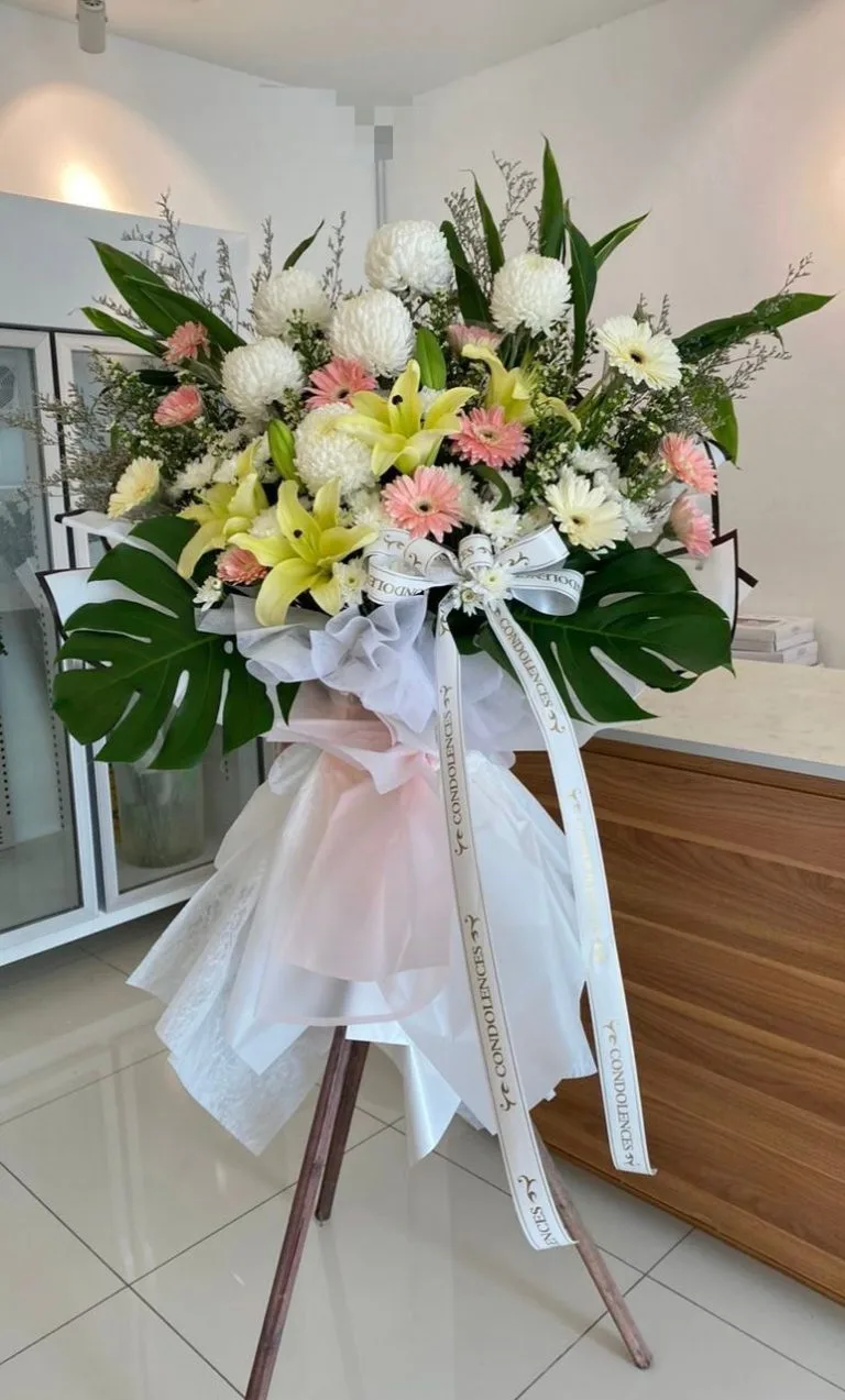 Soft pink and white lily condolence flower arrangement available for flower delivery in Georgetown, Penang