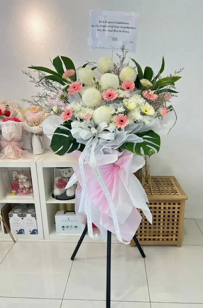 Elegant white pompon and pink gerbera condolence flower stand for flower delivery in Georgetown, Penang