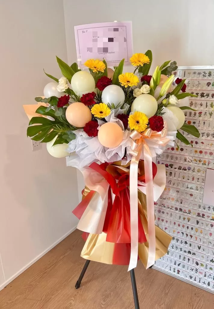 Bright yellow gerbera and balloon stand available for flower delivery in Georgetown, Penang
