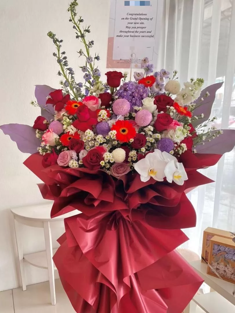 Elegant deep red and purple grand opening flowers wrapped in burgundy in Penang